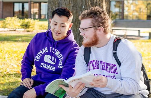 students studying outside on campus